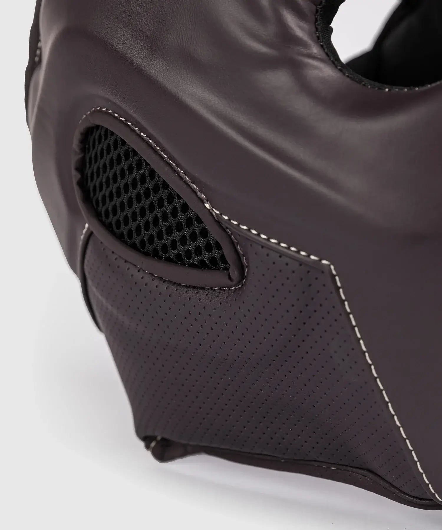 Close-up of chocolate brown Casque Venum Impact Evo boxing headgear with ventilated mesh and premium leather design