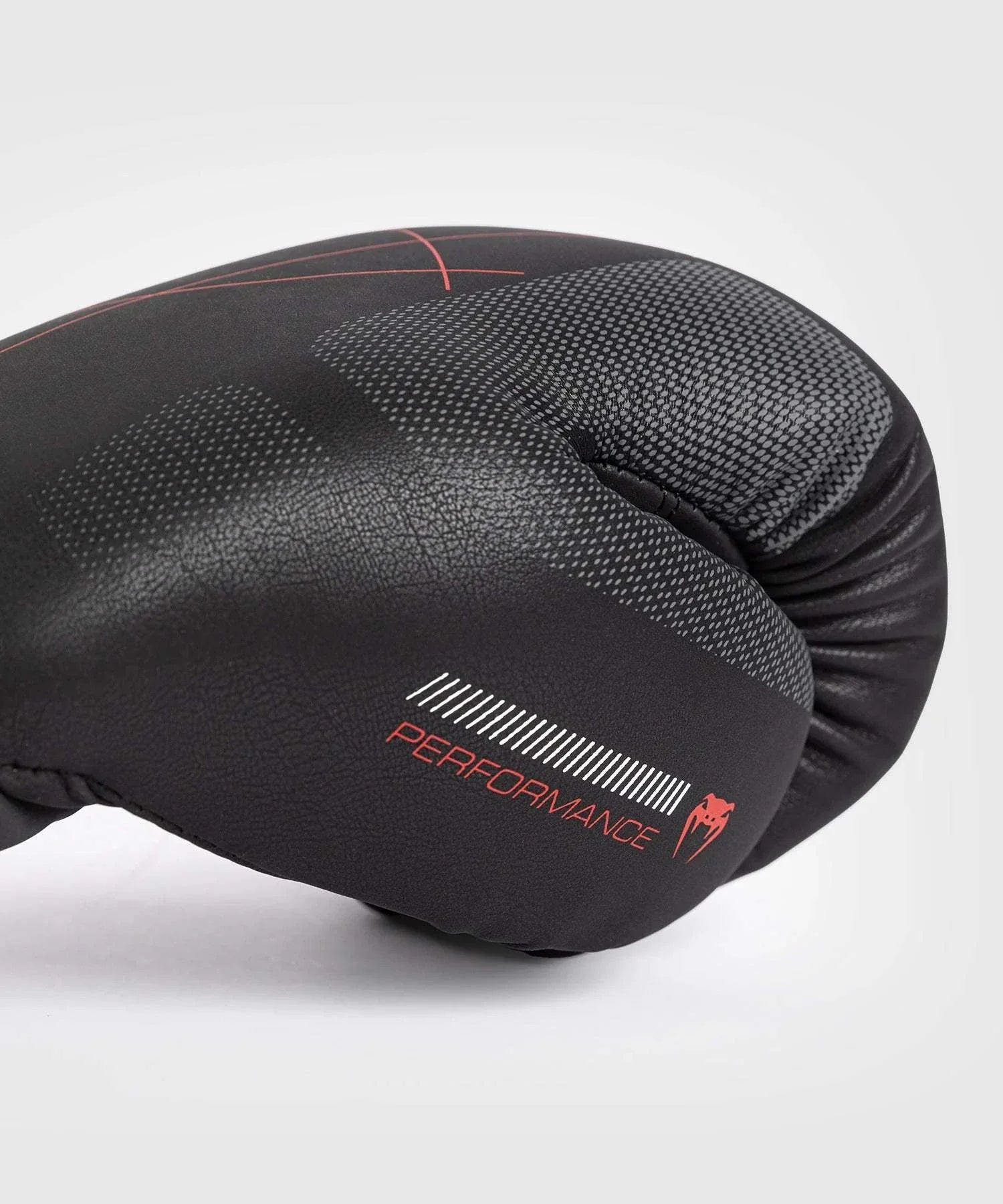 Close-up of black and red Gants de Boxe Venum Tactical XT boxing glove with performance branding and textured surface.