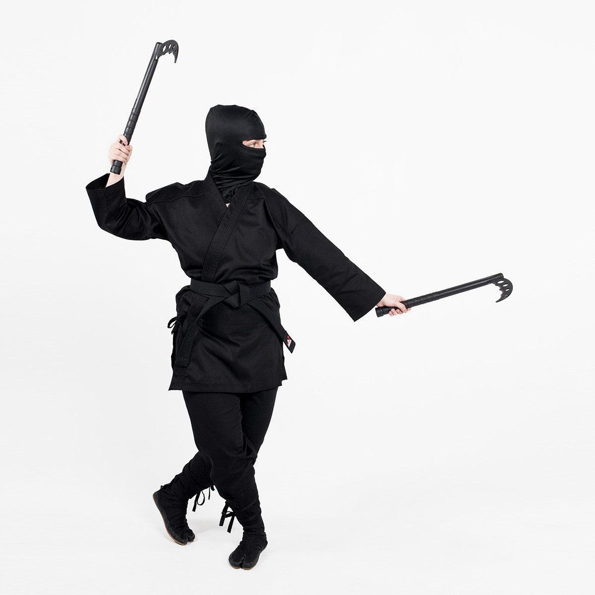 Ninja dressed in black demonstrating FUJIMAE black polypropylene kamas pair for martial arts training