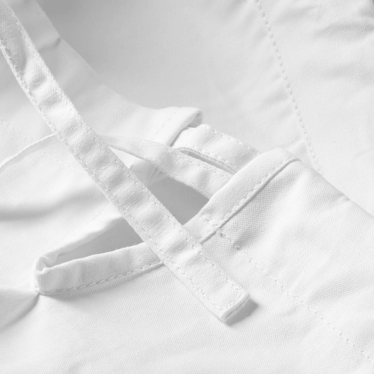 Close-up of white Mizuno karategi pantalon cord and stitching detailing