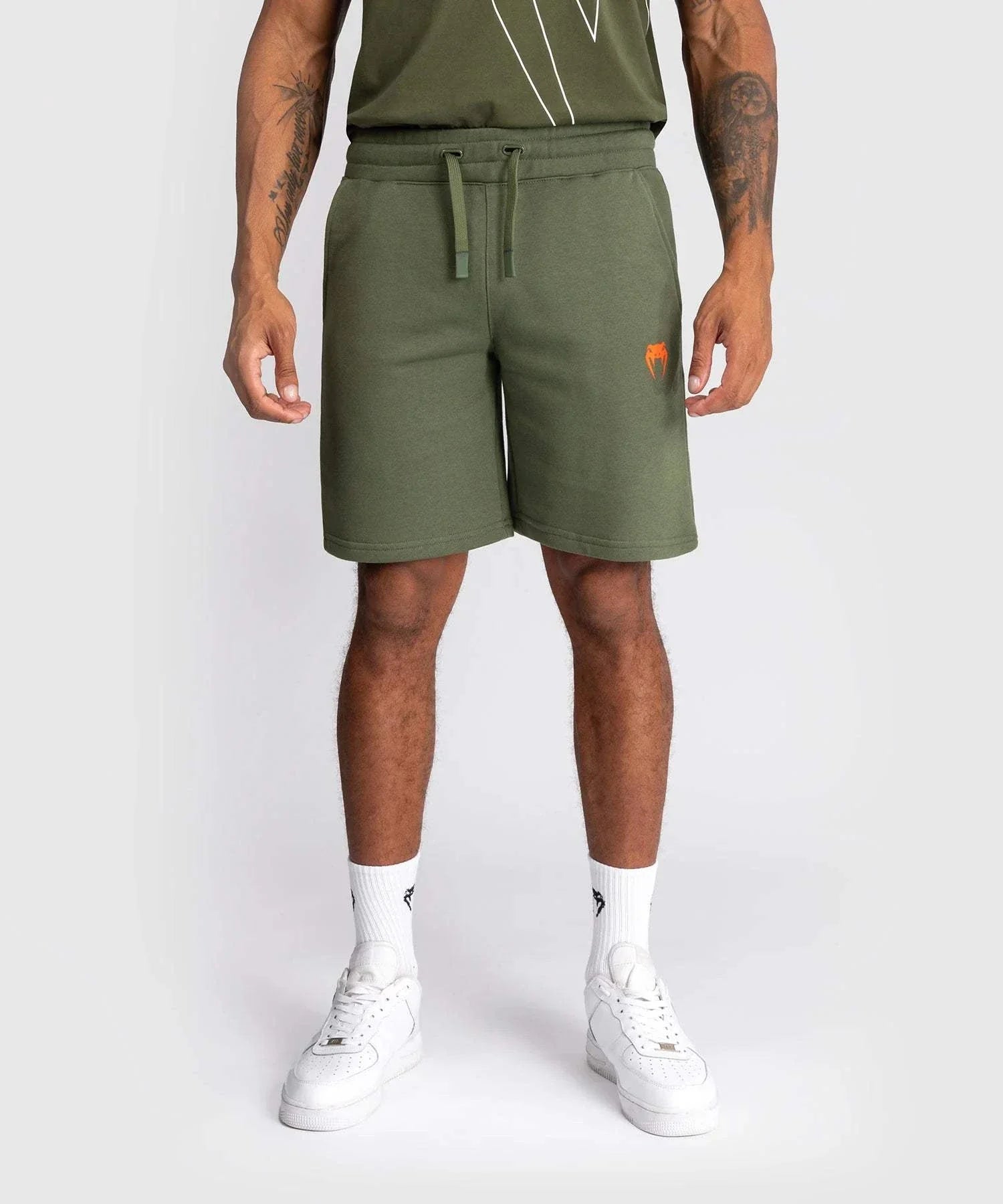 Men wearing kaki Shorts Venum Classic with elastic waist and orange logo on left side
