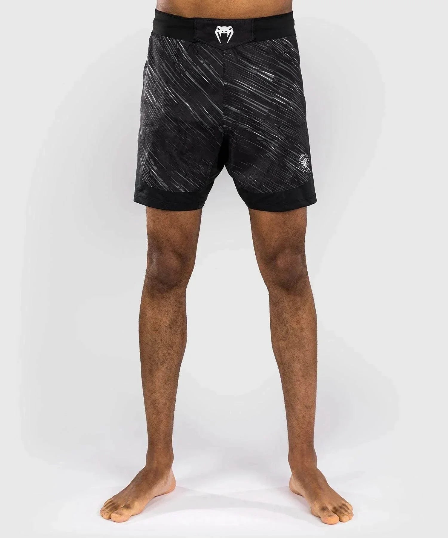 Black and gray Venum Rapid fight shorts designed for MMA and grappling with lightweight ripstop fabric and ergonomic fit.