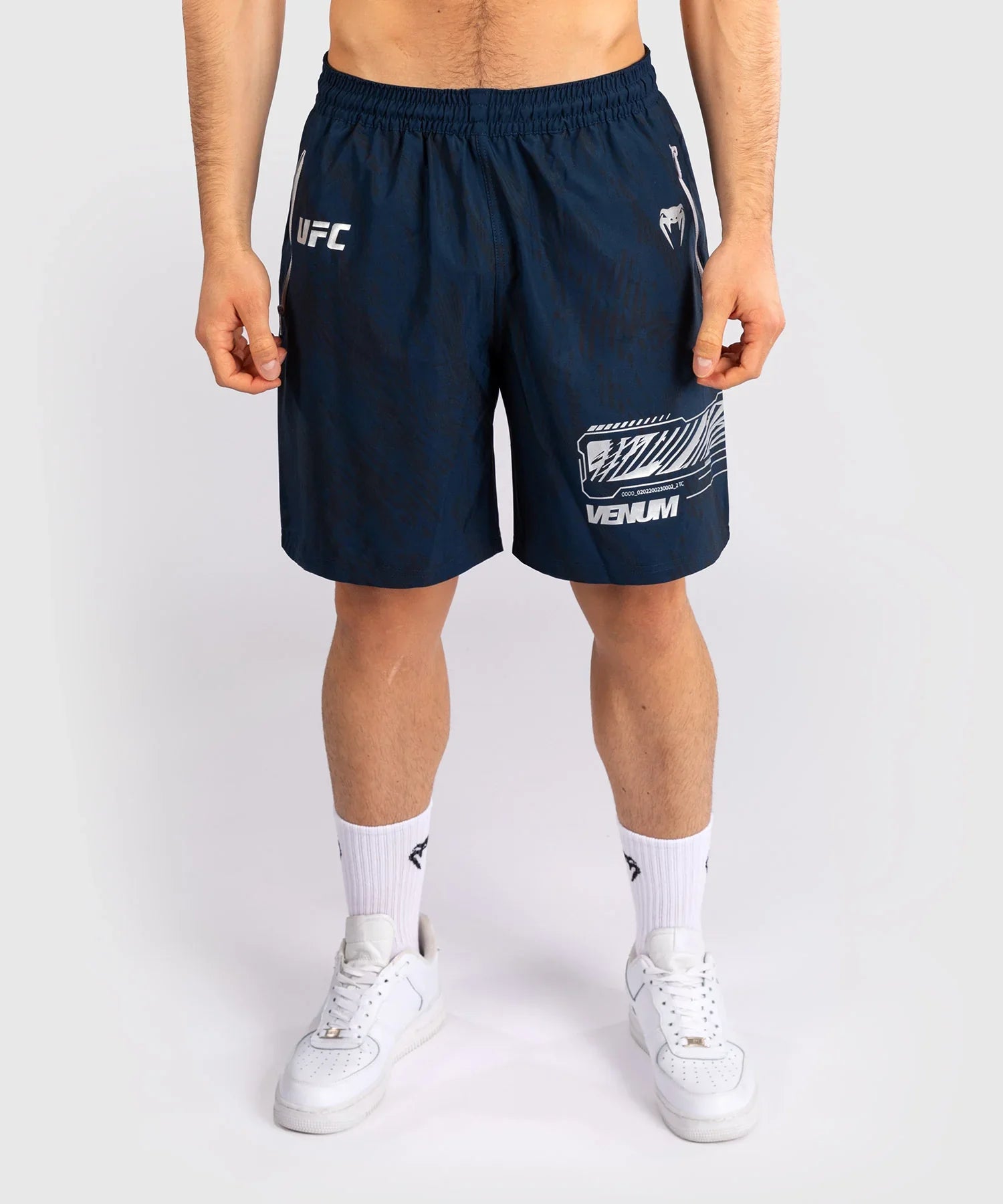 Men wearing navy blue UFC Fusion par Venum performance shorts with elastic waistband and branded logos.