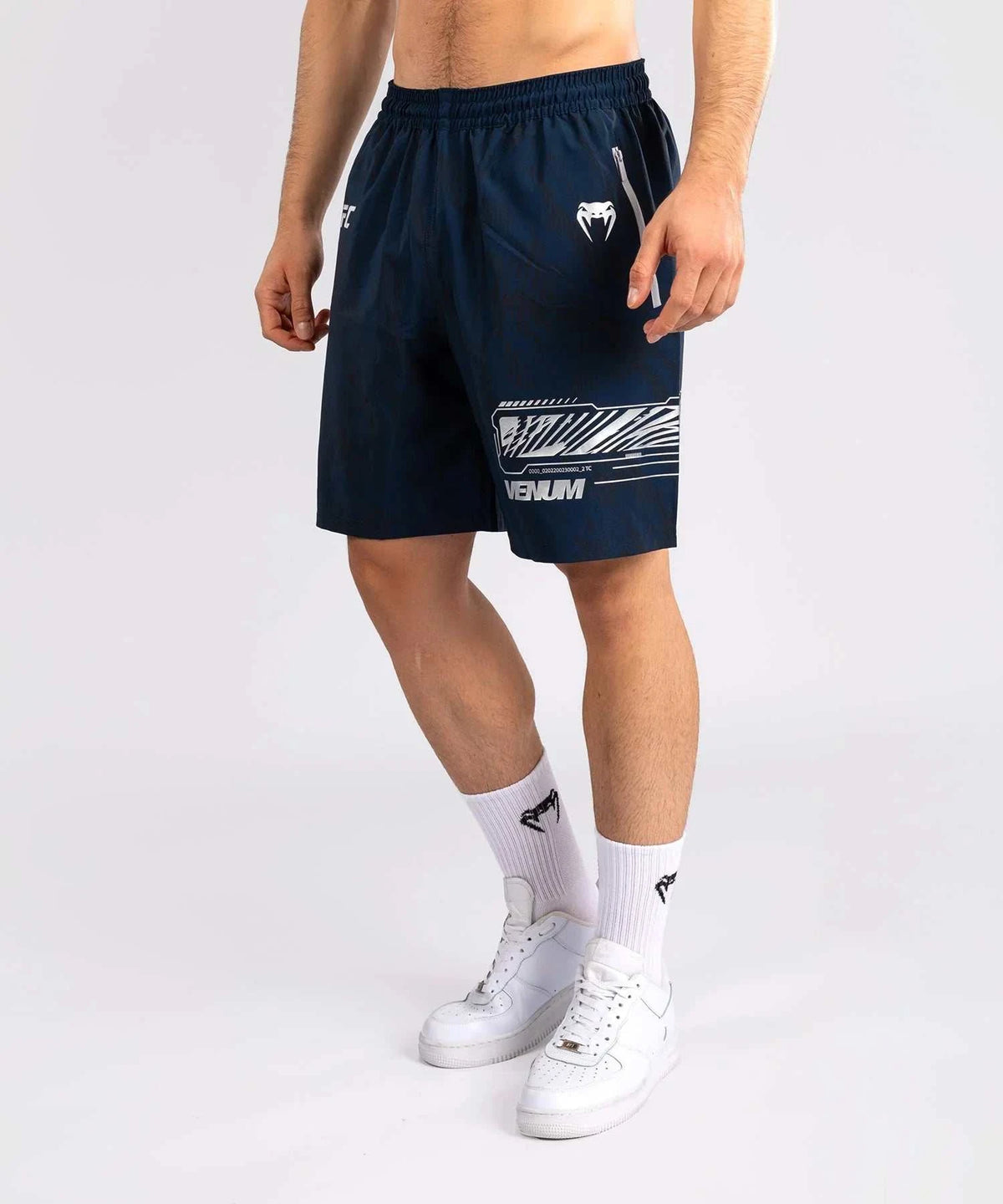 Men wearing navy blue UFC Fusion par Venum performance shorts with elastic waistband and graphic design on white background