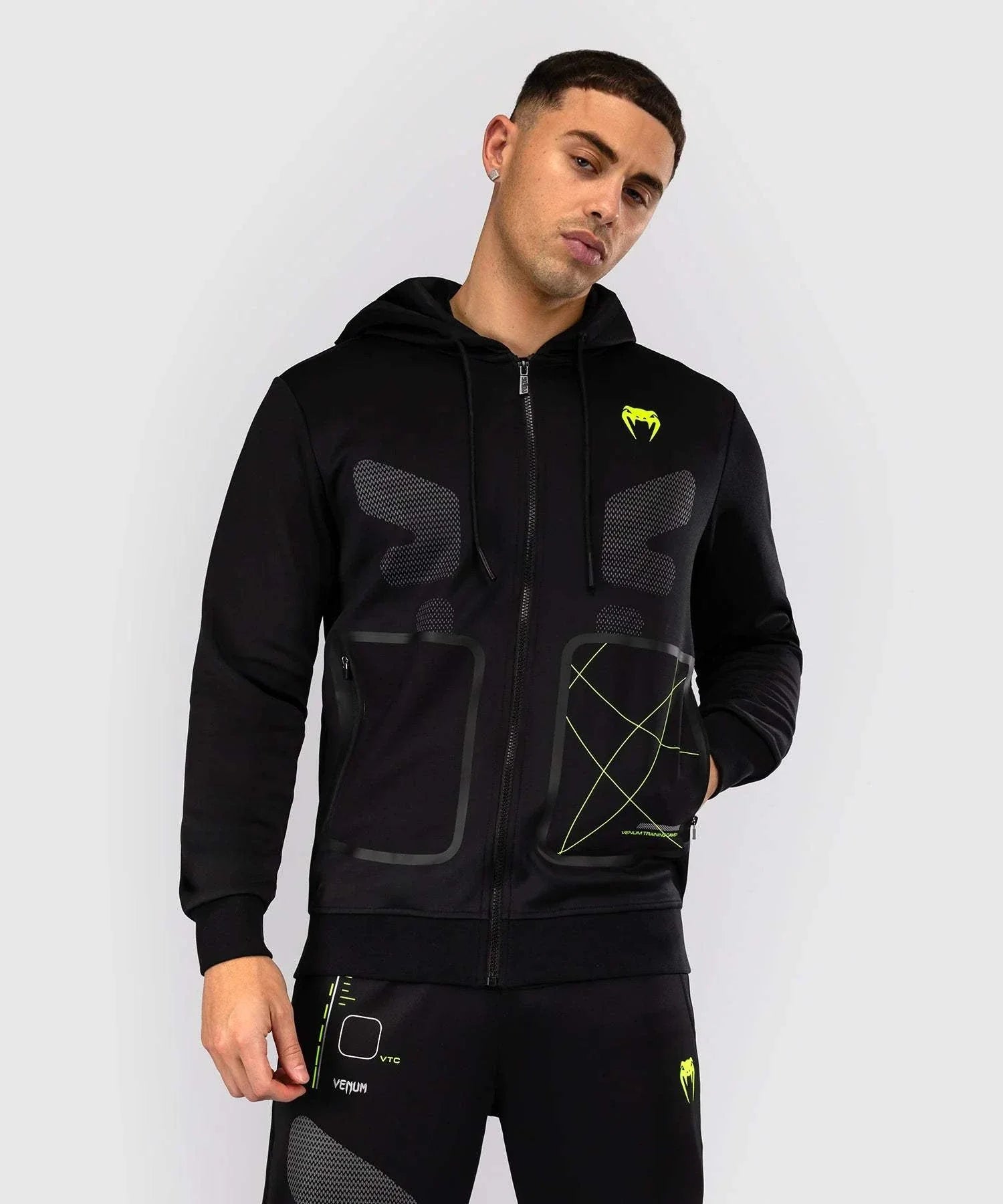 Black and neon green Venum Training Camp 4.0 zip-up hoodie with breathable Dry Tech fabric and adjustable hood for MMA and fitness training