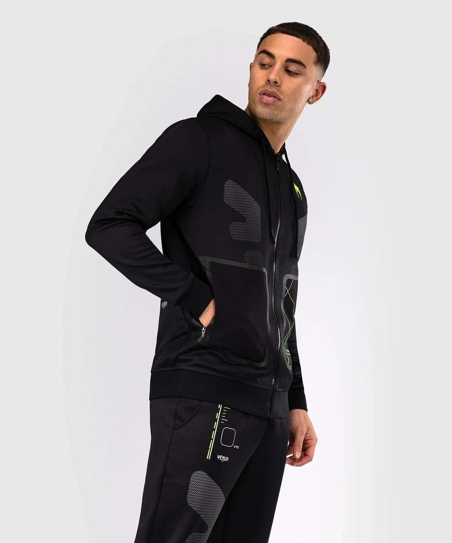 Black and neon green Venum Training Camp 4.0 zip-up hoodie with breathable Dry Tech fabric and adjustable hood