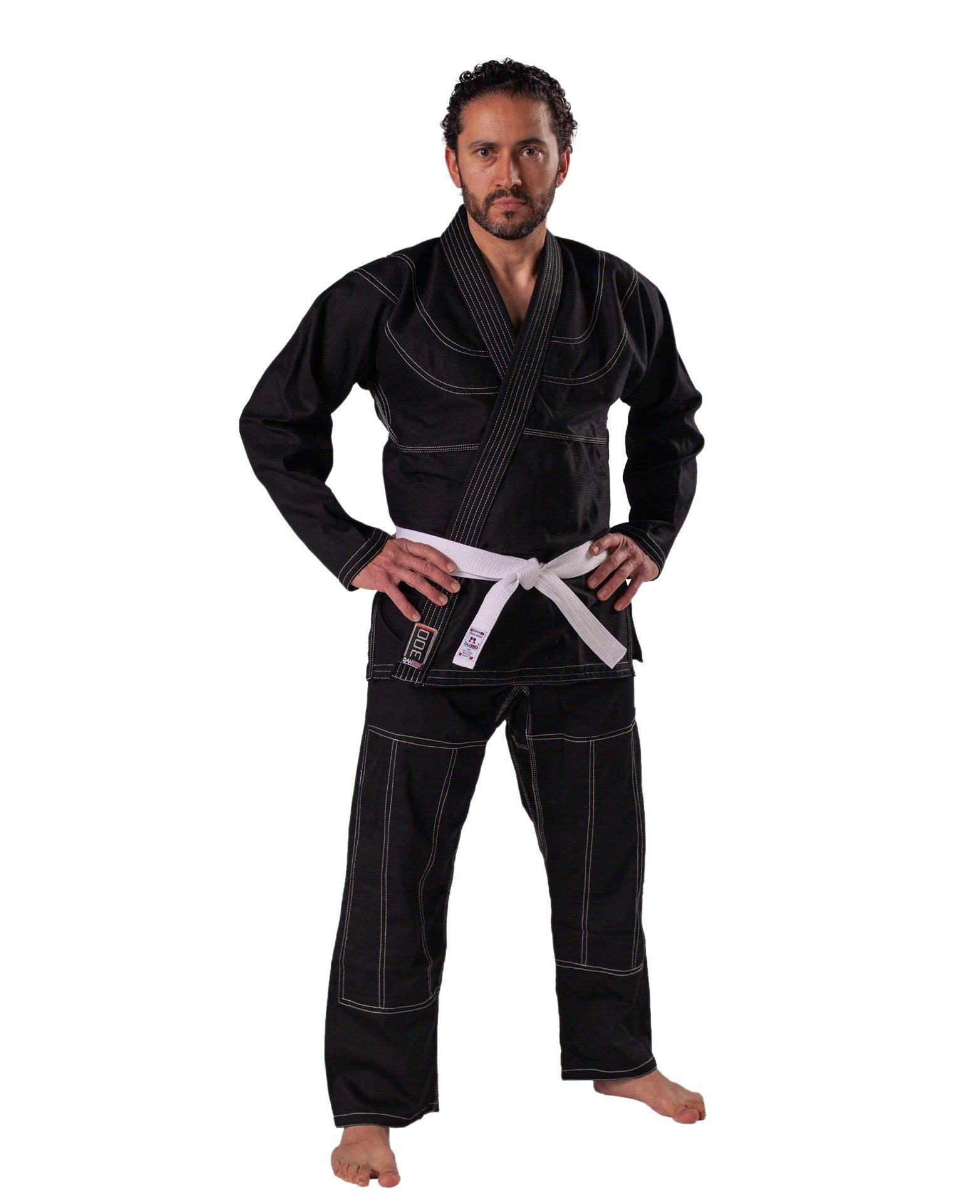 Man wearing black DANRHO Kimono Brazilian Jiu Jitsu gi with white belt and reinforced stitching