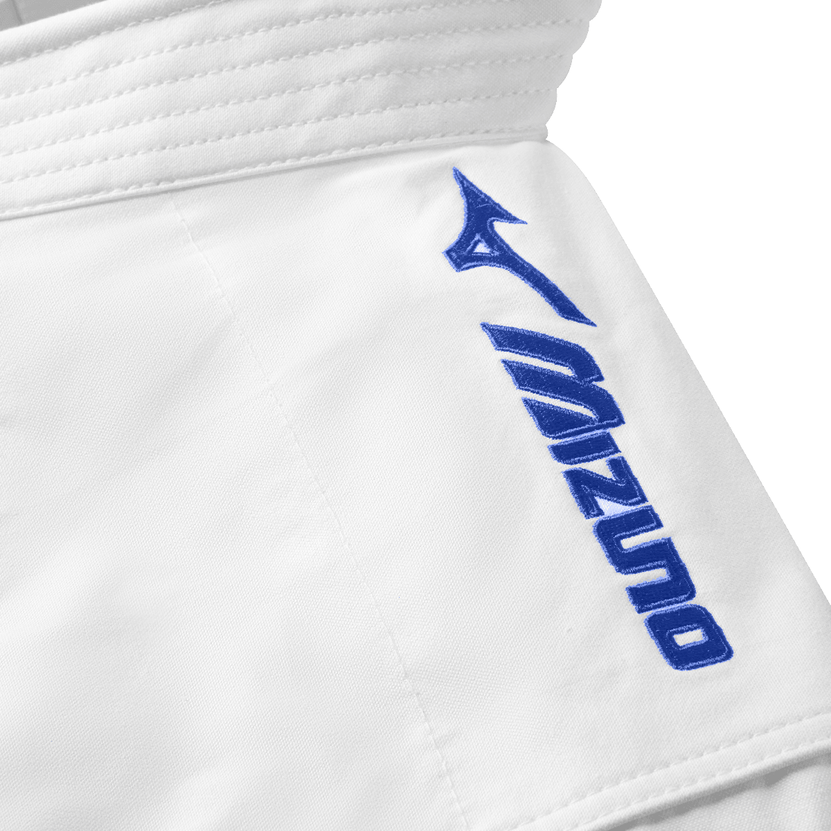 Close-up of white Mizuno karate kimono jacket with blue embroidered logo on shoulder designed for kata competitions