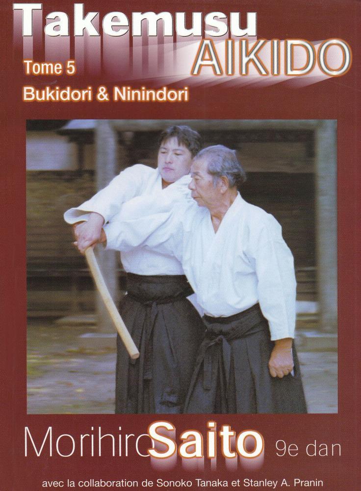 Takemusu Aïkido Vol 5 book cover showing two aikido practitioners demonstrating bukidori technique with wooden weapon, by Morihiro Saito.