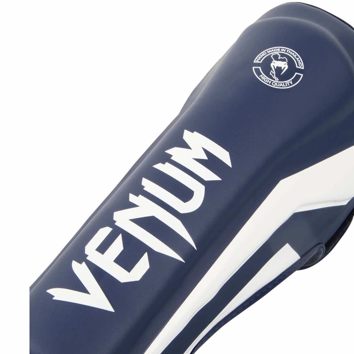 Venum Elite shin guard in blue Skintex leather with white logo and ergonomic design for Muay Thai and kickboxing protection