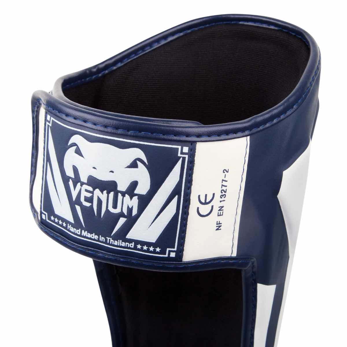 Venum Elite shin guard in premium Skintex leather with ergonomic design and velcro closure for superior protection in kickboxing and Muay Thai.